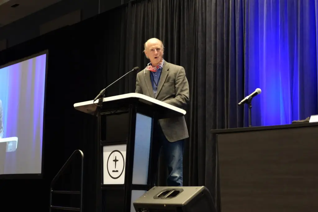 man speaking at podium