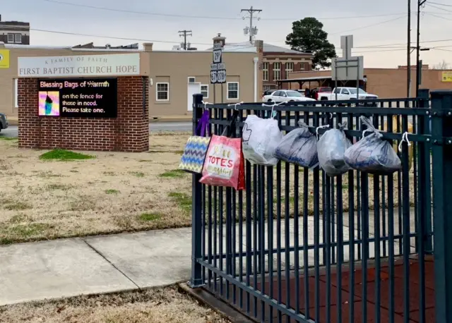 fence with bags tied to it